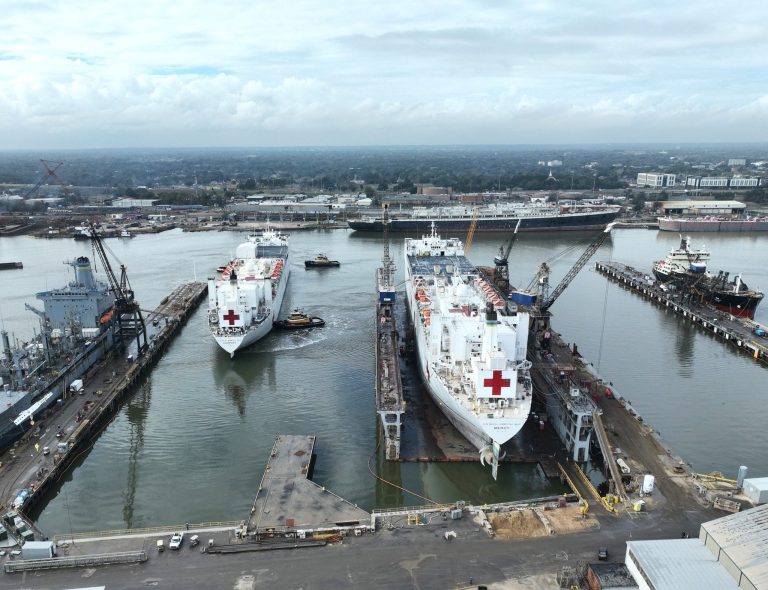 The hospital ships USNS Mercy (right) and USNS Comfort sit side by side at Alabama Shipyard in Mobile, Ala., during scheduled maintenance in early 2026 — a rare sight with both Navy hospital ships in port at the same time. Photo released Jan. 23, 2026, by Alabama Shipyard.